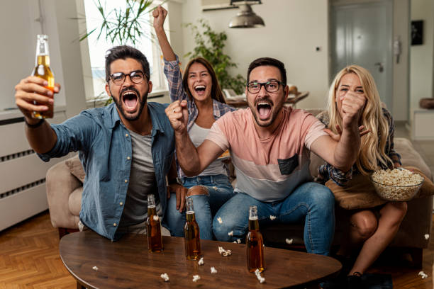 istock Friends watching sport on tv 1297686355