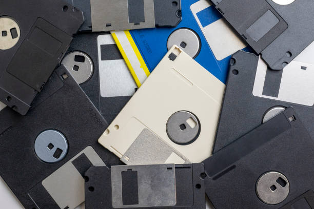 istock Scattered old floppy disks close-up, top view. 1980s and 1990s computer technology. 1297687073