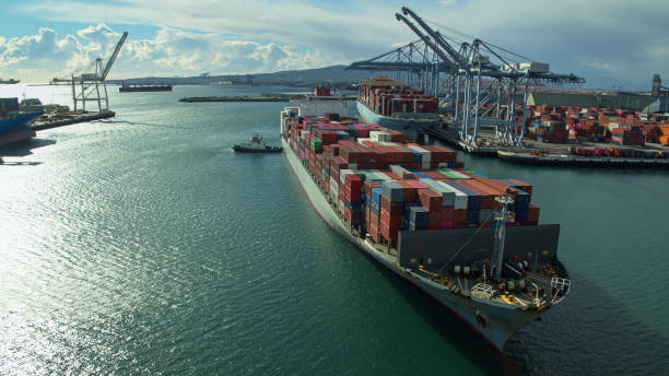 istock Tugs Pulling Container Ship Towards Berth in Port of Long Beach 1297687824