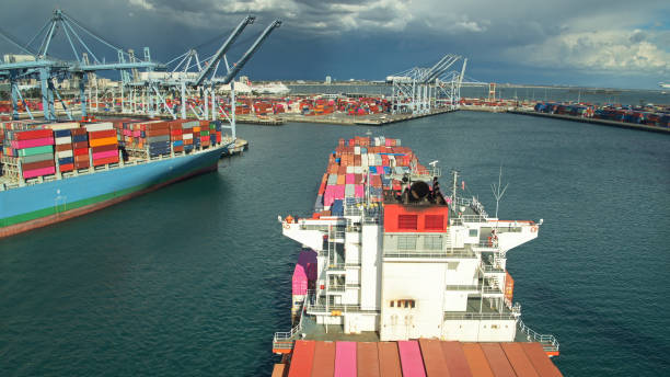 istock Cranes Extended Over Container Ships in Port - Aerial 1297687829