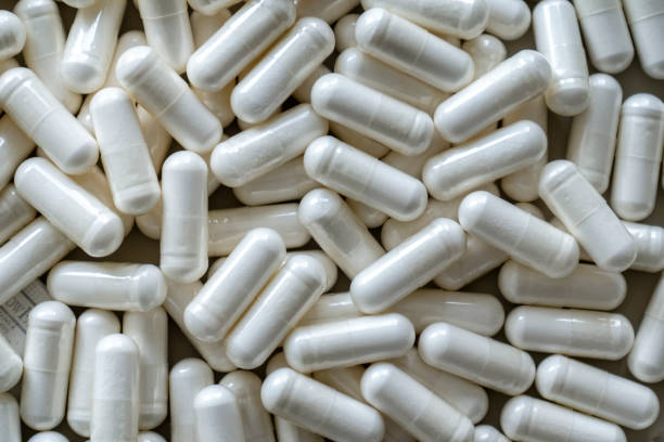 istock Pile of white medicinal pills 1297687895
