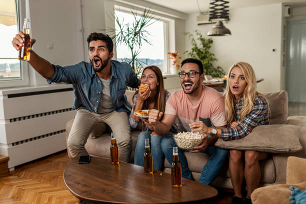 istock Friends watching sport on tv 1297688716