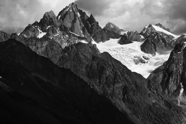 istock High rocky mountains with glacier in storm clouds before rain 1297688801