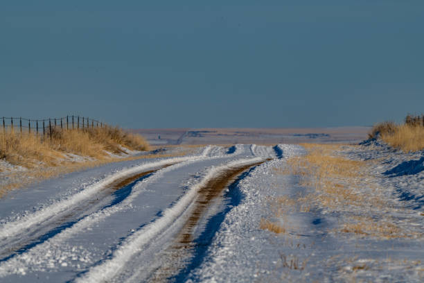 istock Northern prairie road covered with snow 1297690914