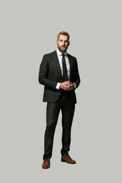 istock Good looking Scandinavian businessman looking sharp wearing a grey suit and tie with brown shoes. 1297694013