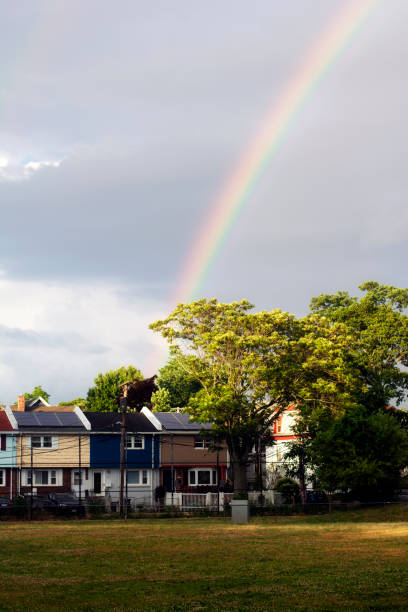 istock Colorful rainbow over residential homes 1297700739