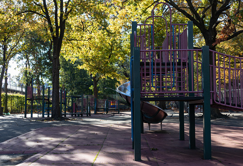 An empty urban playground with trees during autumn in Flushing Queens of New York City