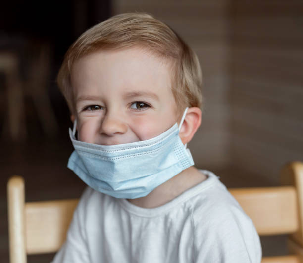 istock a boy sitting in a medical mask 1297706505