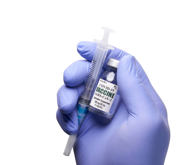 istock Hand holding Covid-19 vaccine with syringe on white background 1297707321
