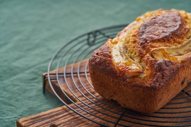istock Banana bread, cake with banana. Whole loaf on grid. Side view 1297708823