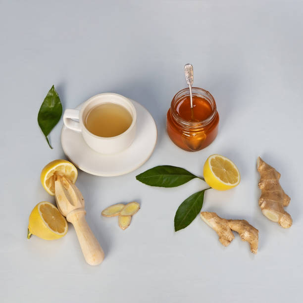 istock Ginger, honey and lemon herbal tea on light grey background. 1297708918
