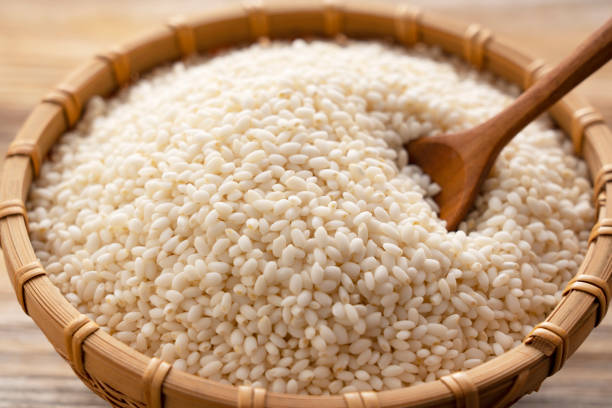 istock Glutinous rice in a bamboo colander set against a background of trees with copy space 1297709689