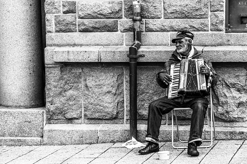 Alesund, Norway - July 10, 2013: An accordian player performing on the streets of Alesund in Norway