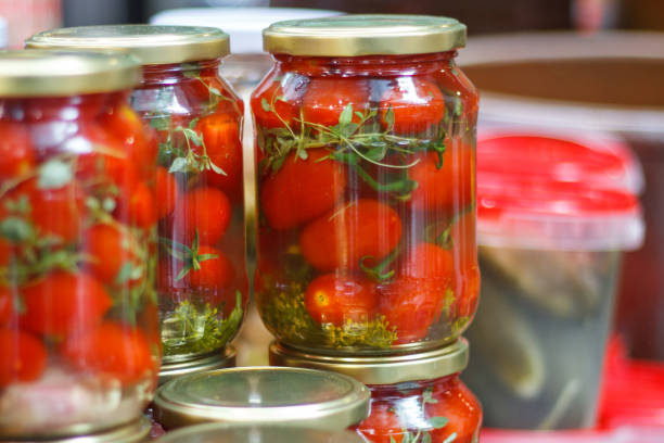 istock Marinated tomatoes in glass jar. Healthy snack 1297712983