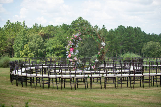 istock Unique round spiral chair pattern wedding ceremony setting at rolling hills countryside with brown chiavari chairs and white cushions 1297713050