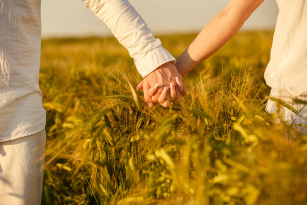 istock Couple holding hands while walking in nature 1297718831
