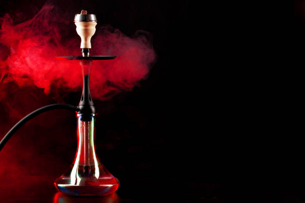 istock Smoking hookah on black background with color fog 1297719912