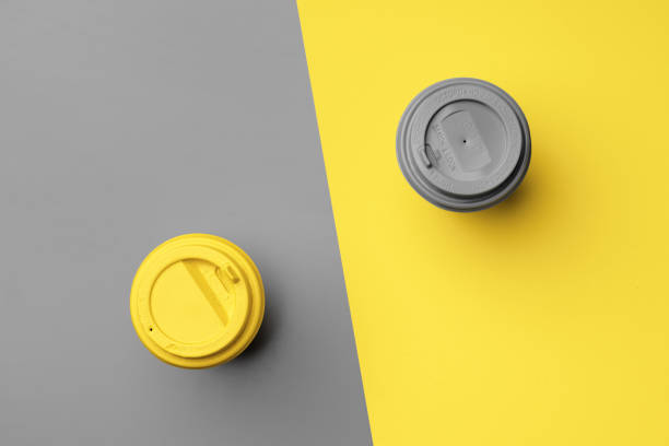 istock Disposable coffee cup in yellow gray colors 1297720777