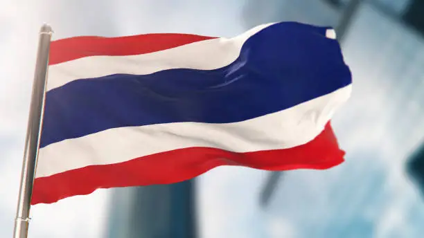 Photo of National Flag of Thailand Against Defocused City Buildings