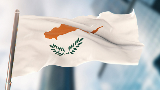 National Flag of Cyprus Against Defocused City Buildings