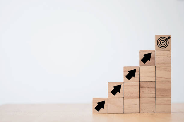 istock Virtual target board and increasing arrow which print screen on wooden cube. Business achievement goal and objective target concept. 1297722790