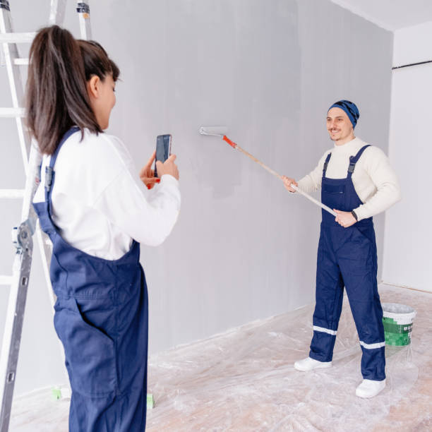 istock Cheerful young couple standing and making selfie at new home 1297724483