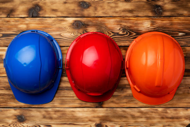 istock Work safety protection hardhat on wooden background 1297725580