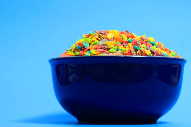 View of large blue bowl filled with rainbow colored cereal.