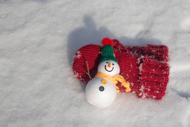 istock red knitted mittens laying on the snow. 1297729823
