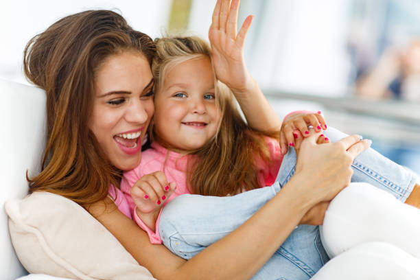 istock Cheerful single mother spending time with her daughter at home. 1297730813
