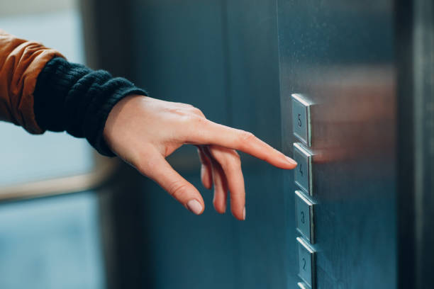 istock Close up of forefinger pressing the button elevator during coronavirus pandemic covid-19 quarantine concept 1297731350
