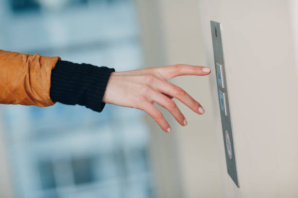 istock Close up of forefinger pressing the button elevator during coronavirus pandemic covid-19 quarantine concept 1297731351