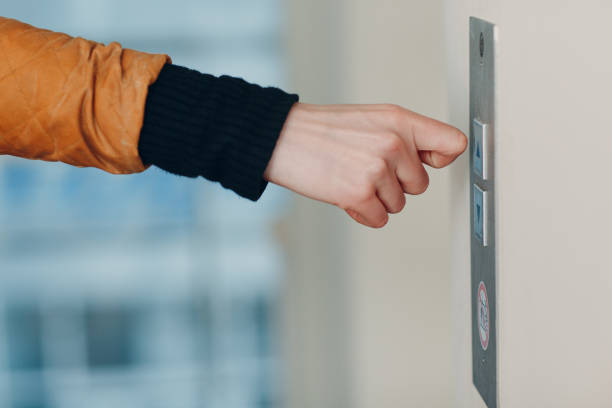 istock Close up of forefinger knuckle pressing the button elevator during coronavirus pandemic covid-19 quarantine concept 1297731352