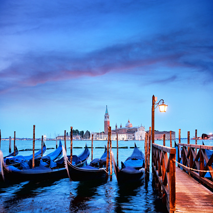 Gondolas at twilight in Venice, Italy. Composite photo