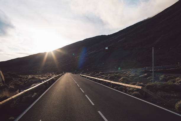 istock Road Leading Towards Mountain Against Sky 1297733665