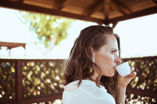 istock pensive modern woman in white shirt 1297734124