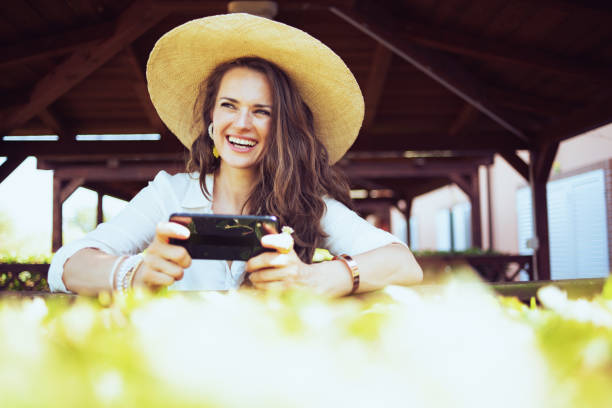 istock smiling woman in shirt using smartphone applications 1297734679