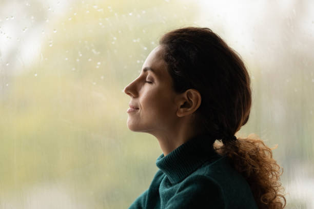 istock Calm young woman breathe fresh air meditating 1297735538
