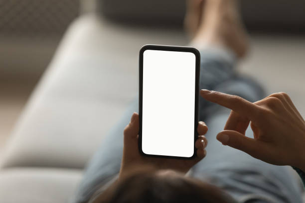 istock Close up of woman use smartphone with mockup screen 1297735567