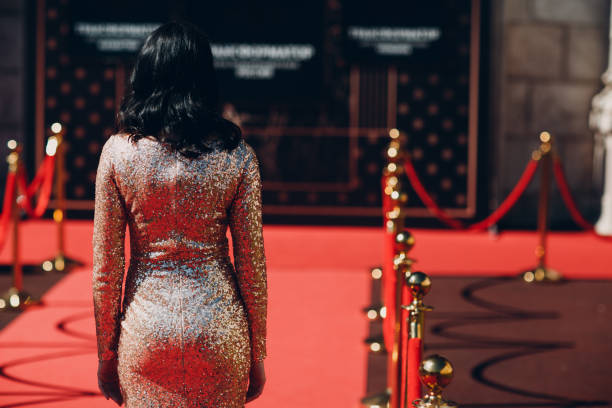 Woman in a luxurious dress on a red carpet. Woman in a luxurious dress on a red carpet artists model photos stock pictures, royalty-free photos & images