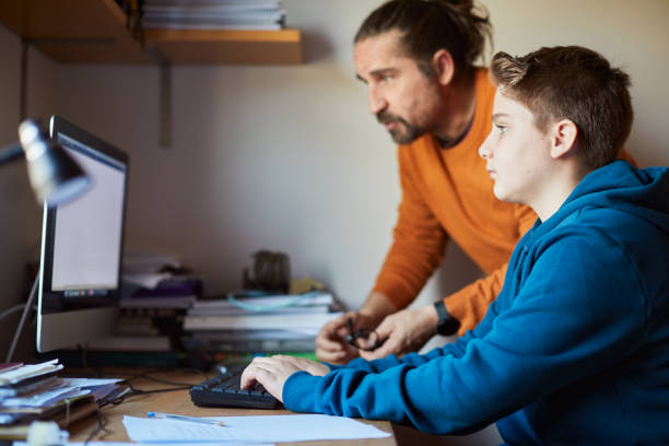 istock Father helping his son with his homework. 1297737375