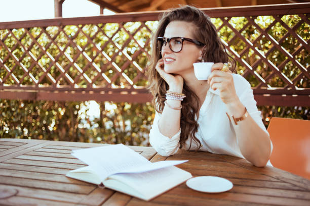 istock pensive woman in shirt drinking coffee and reading 1297737623