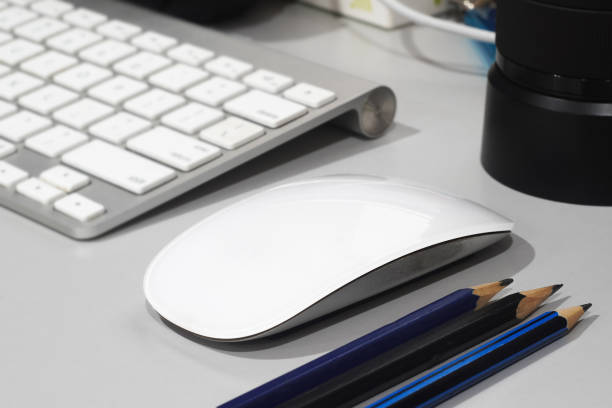 pencil, wireless mouse and keyboard stock photo