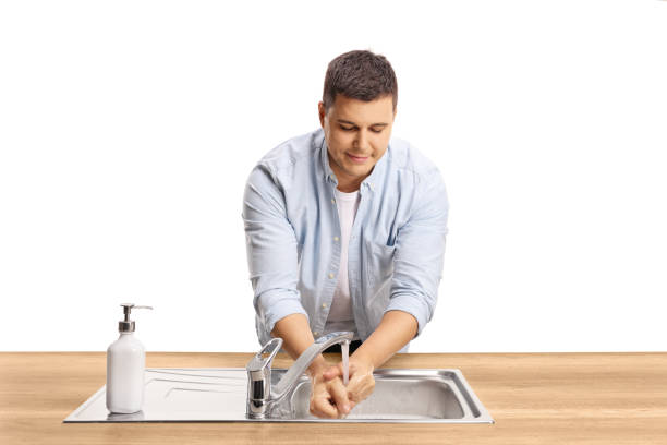 istock Young casual man washing hands in a sink 1297737718