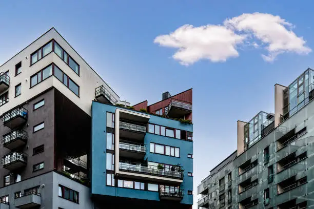 Cityscape of contemporary apartment buildings against blue sky