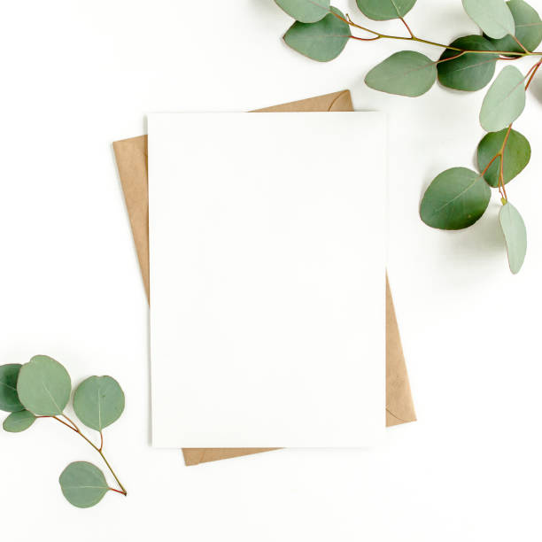istock Mockup invitation, blank greeting card and green leaves eucalyptus. Flat lay, top view 1297738612