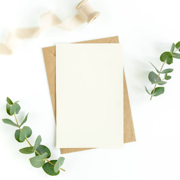 istock Mockup invitation, blank greeting card and green leaves eucalyptus. Flat lay, top view 1297739238