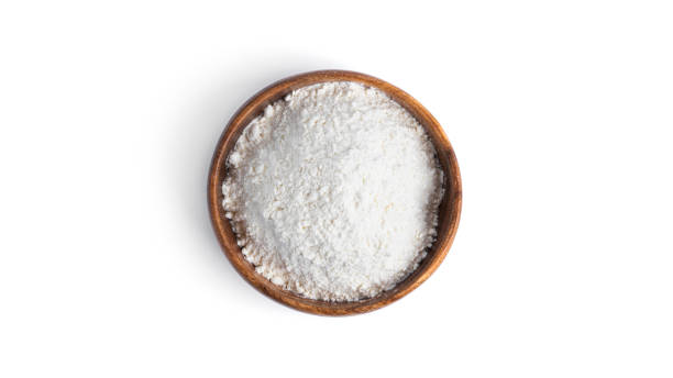 istock Flour in a wooden bowl isolated on a white background 1297739347