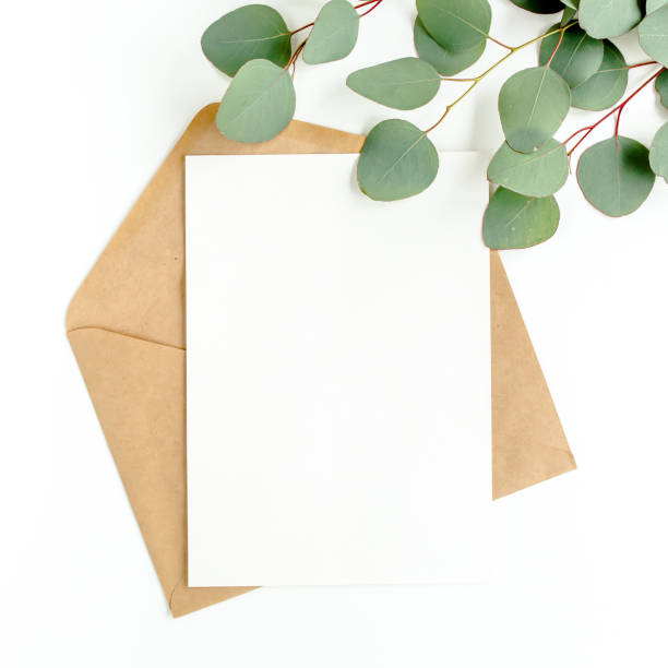 istock Mockup invitation, blank greeting card and green leaves eucalyptus. Flat lay, top view 1297739981