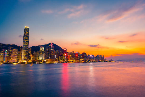 Hong Kong neon sunset iconic harbour skyscrapers illuminated panorama China Hong Kong neon sunset iconic harbour skyscrapers illuminated panorama China Victoria Bay stock pictures, royalty-free photos & images